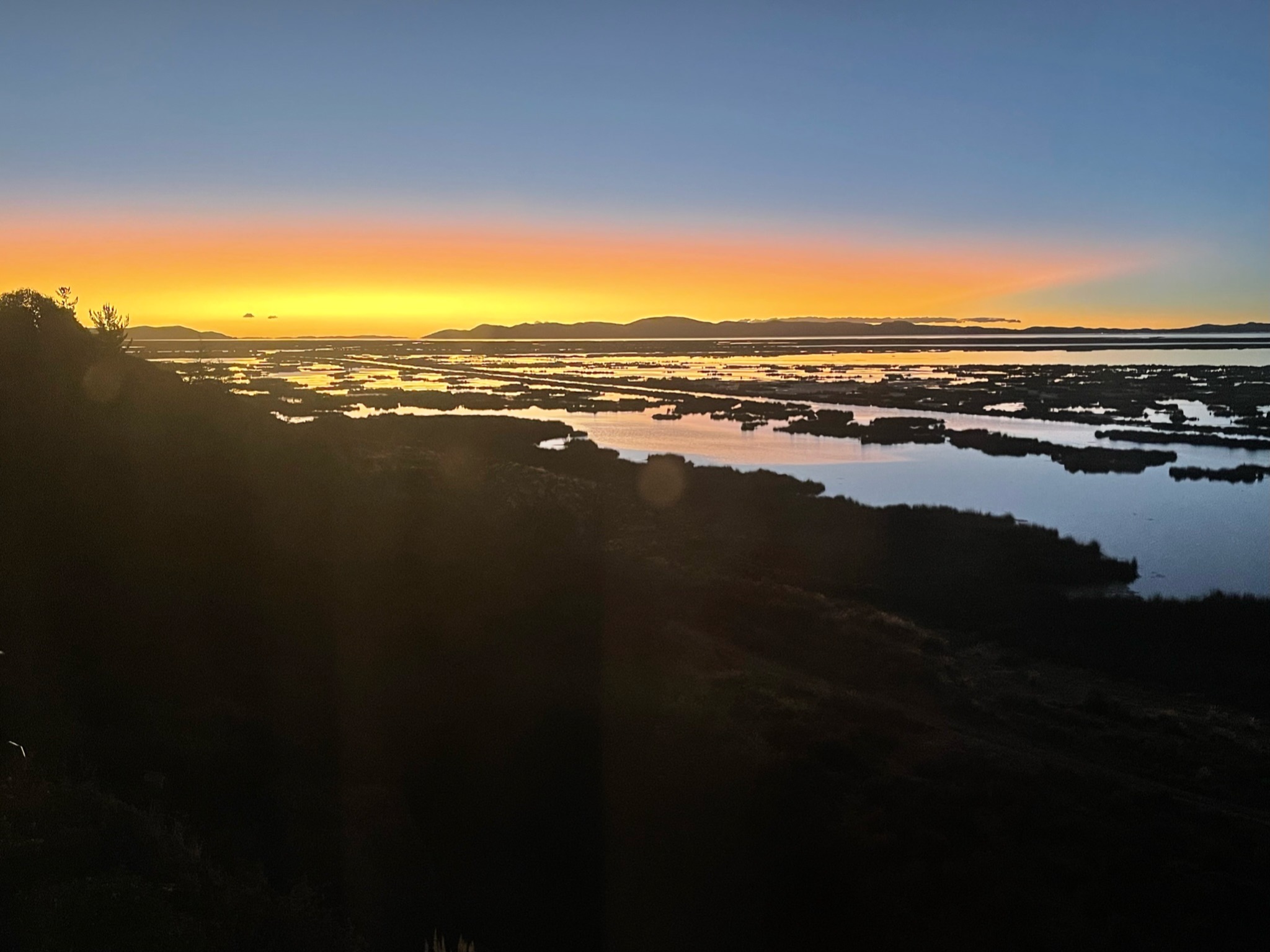 Atmospheric horizon over water at sunrise
